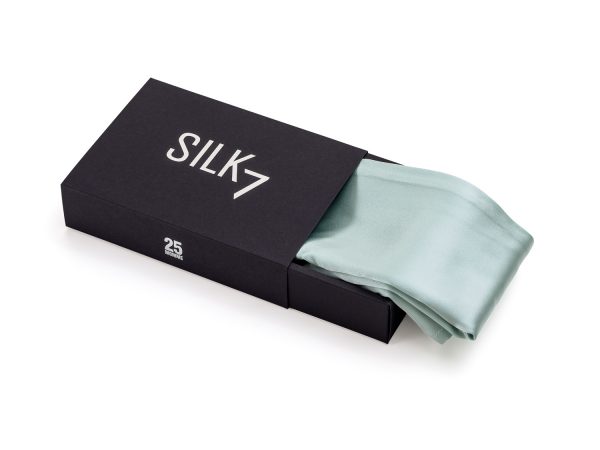 mint green silk pillowcase half out of box